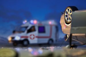 A car rollover with ambulance in the background. The reality of the situation is that not every car crash involves only property damage. Every day people sustain both minor and serious injuries as a result of auto accidents.