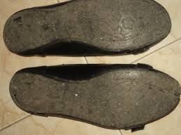 A worn  pair of shoes. Shoes get worn-out and should be replaced to prevent trip and falls or slip and fall accidents.
