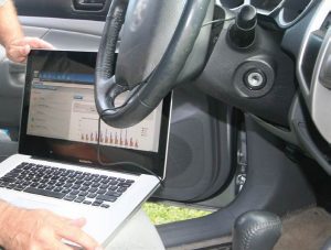 A computer inside a car connected to the dashboard looking at vehicle data. Did you know that vehicles today are equipped with an event data recorders (EDR) or vehicle black box data recorders?