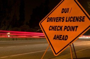 An orange and black DUI / drivers license checkpoing ahead sign. Drunk driving solution? No more excuses to drink and drive.. 