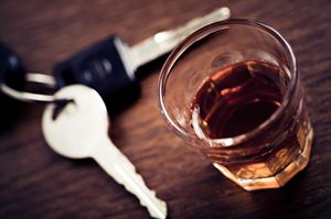 Keys next to a glass of alcohol. The NTSB recommends lowering the legal limit - blood-alcohol level. 
