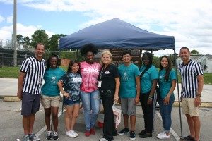 Photo of attorneys Scott Murray and Jason Guari with the SADD Committee at Royal Palm Beach High School for their annual Battle of the Belts competition 