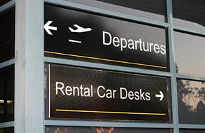 Airport direction signage of Departures and the Rental Car Desks. How Safe is Your Rental Car? Has it been recalled or is it defective?