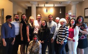 The Attorneys and Staff of Murray Guari Trial Attorneys with Red Noses on for Red Nose Day.