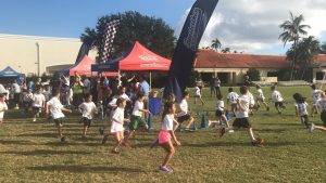 Elementary School kids running on grass in a race