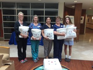 Four Good Samaritan Staff Members with Blankets for Love Palm Beach Co-Founder