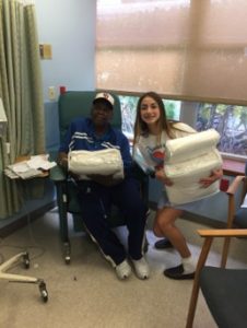 A Blanket of Love Palm Beach delivers a blanket to a Good Samaritan patient receiving treatment.