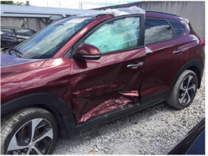 Side door damage on a red car in an accident
