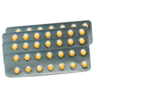 Rabeprazole : Small round light yellow enteric-coated tablet pills in blister pack isolated on white background with copy space. Medicine for treatment gastric ulcer (stomach ulcer) or GERD.