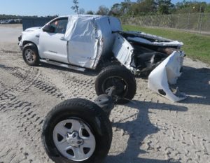 White Pickup Truck damaged in a Vehicle Crash
