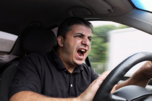 Wide angle look inside in the car of actually driving young male with without belt and being very angry and yelling