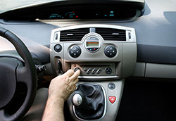 Hand turning dials on vehicle center console