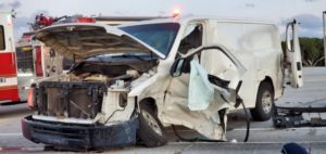 White commercial vehicle with front-end damage in a violation of right-of-way accident