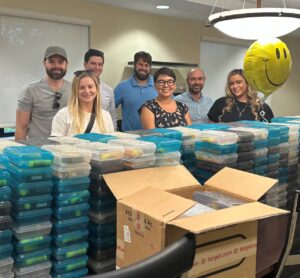 Scott Perry and members of the Palm Beach County Bar Association with room filled with School Supplies to be distributed to local school