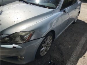 Grey vehicle with driver front-end damage after hitting pedestrian