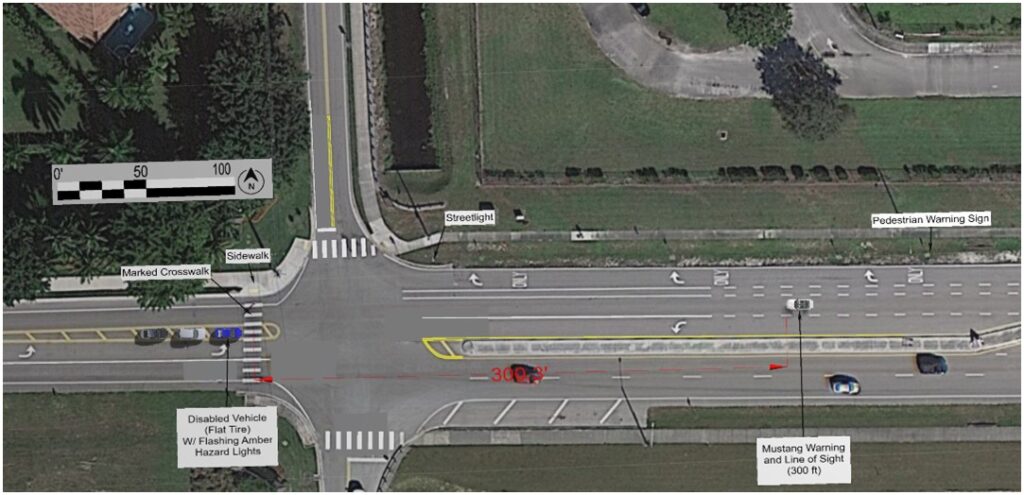 Ariel photo of a four-way intersection with crosswalk with vehicles showing accident scene