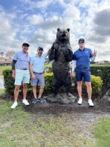 2024 YMCA Golf event - Attorneys posing by Posing by PGA National Bear