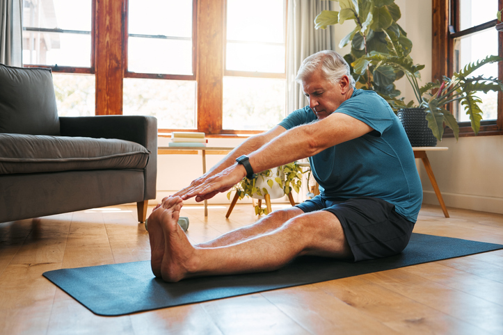 Health, exercise and yoga with senior man doing ground