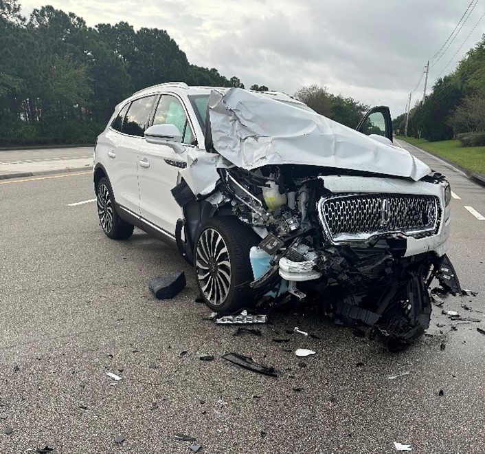 White SUV with front end damaged due to car accident