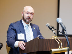 Partner and Annual Unity Seder Co-Chair at Podium