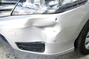 White Car with front end damaged due to a hit and run acccident