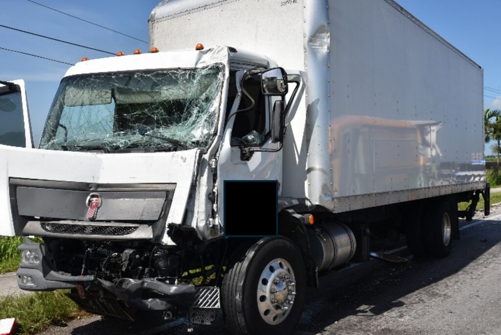 Damaged White Commercial Vehicle involved in an auto accident.