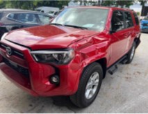 Red SUV with Front and Driver Side Damage